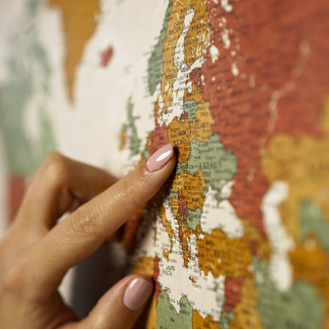 bir kisi retro renkli dunya haritasi kanvas tablo uzerinde avrupa bolgesini isaret ediyor yakin plan colorfullworldstr